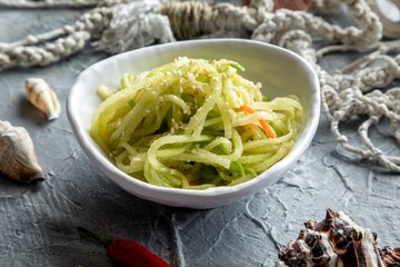 Sichuan radish. Green radish salad with carrots and cayenne pepper.