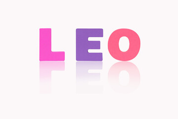 Name LEO is in 12 Zodiac isolated on white background. Colorful wooden alphabets set sort. English letter made of wood arrange alphabet as categorize suitable for children. Poster, banner design. 