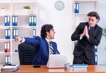 Boss and his male assistant working in the office