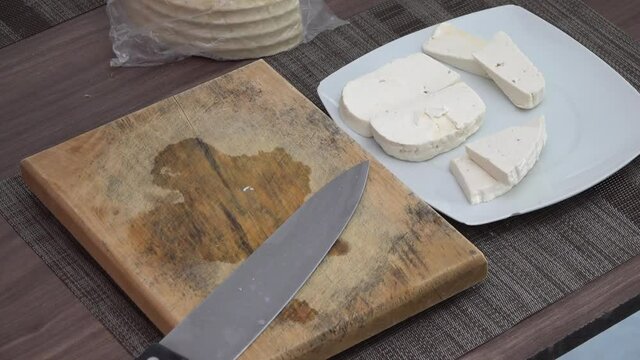 Cheese being cut on a table