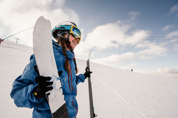 Mountaineer backcountry ski walking ski alpinist in the mountains. Ski touring in alpine landscape with snowy trees. Adventure winter sport.