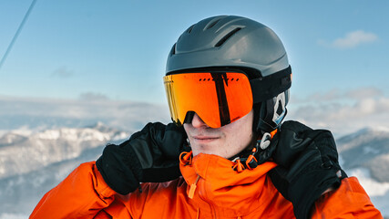  Winter sports and leasure activities. Portrait of a happy male skier in the alps