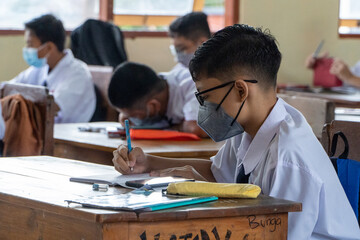BALI,INDONESIA-5 OCT 2021: classroom atmosphere in Indonesian junior high schools when learning the...