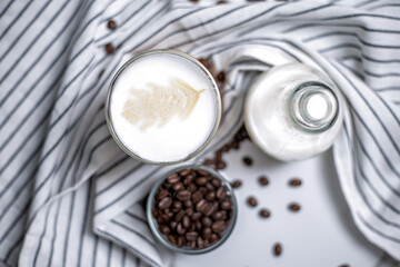 Obraz na płótnie Canvas top view creamer with milk and coffee bean