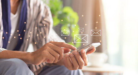 Close-up hand of person using mobile phone with Email  icon and sending, connection and...
