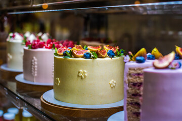 showcase with cakes. appetizing sweets with fruits and berries, figs, blueberries, raspberries