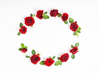 Wreath in the form of a ring of red roses. Composition on a light background. Top view