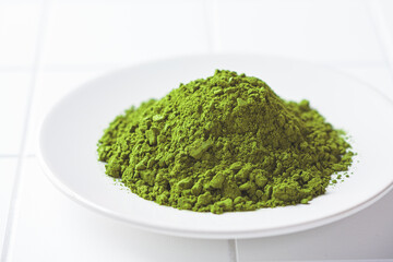 Fototapeta premium Matcha green tea powder on a white plate.