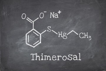 Chemical structure of Thimerosal or Thiomersal , an organomercury compound used as preservative antifungal and antiseptic agent. Blackboard background.