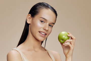 brunette apple in hands posing fruit healthy food fresh beige background