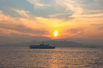 Ferry and Istanbul. Istanbul background photo at sunset with foggy weather.