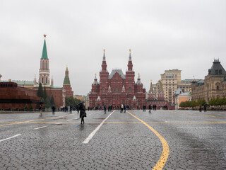 Fototapeta premium Moscow, Russia - October 5, 2021: Red Square. The building of the historical museum against the background of an autumn cloudy sky. Tourists walk around the square.