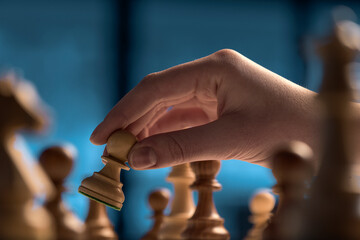 Chess game tournament: the player is moving a pawn