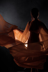 Portrait Swim wear of 20s Asian Woman in shadow low light key with back backlit, side rear view