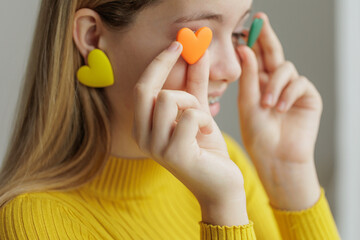 Teenage girl chooses jewelry earrings. Heart shaped earrings. St. Valentine's Day. High quality photo