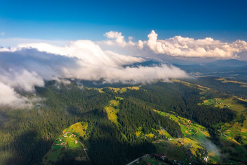 Aerial view of foggy sunrise in the mountains. Carpathian mountains.