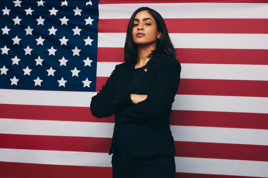 Congresswoman standing against an American flag