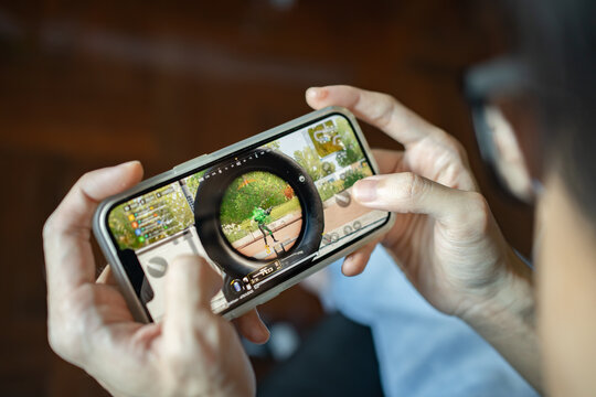 Bangkok, Thailand -January 17, 2022: Gamer playing PUBG: NEW STATE on an iPhone 13.