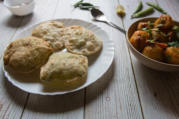 Close up of puri or Indian flat bread deep fried and served in a plate. Selective focus.