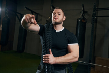 Male athlete posing for camera at gym