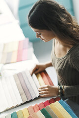 Young interior designer choosing color swatches