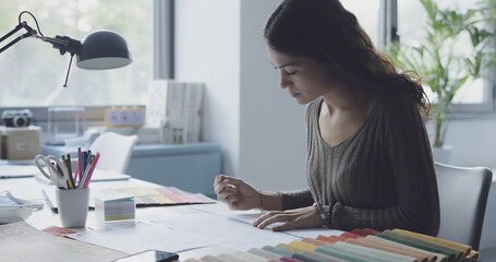 Professional interior designer sitting at desk and working