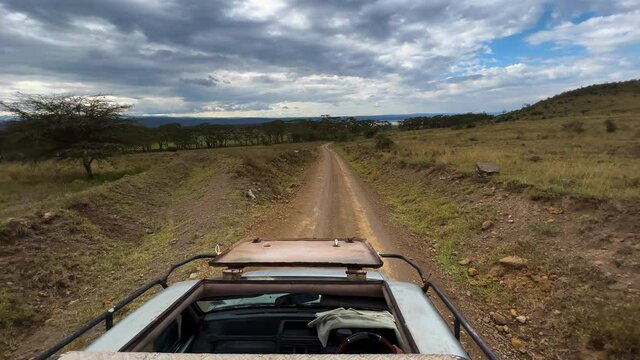 Safari Vehicle Driving On The Track Through Savanna In Lake Nakuru National Park In Kenya. POV