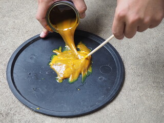 Man pouring glue mousetrap. closeup photo, blurred.