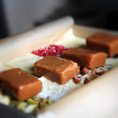 Beautiful candy caramels toffee on piano keys with pink ribbon