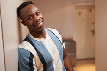 Multiethnic person indoors looking at camera with smile