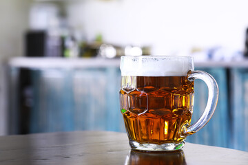 Glass of fresh beer on a wooden table. Lager beer mug on stone table. Top view with copy space