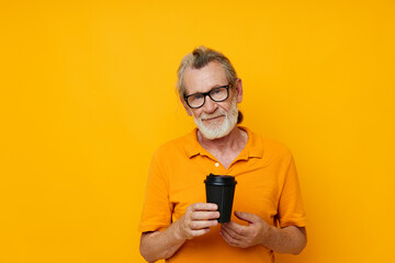 Portrait of happy senior man with black disposable cup isolated background