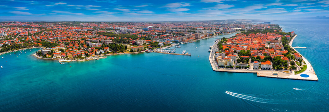 Fototapeta Zadar, Croatia - Aerial panoramic view of the old town of Zadar by the Adriatic sea with motorboat, yacht harbor and blue sky on a bright summer day