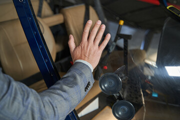 Caucasian male examining modern unmanned private chopper