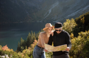 Naklejka premium Young tourist couple, man and woman, on hiking path in mountains