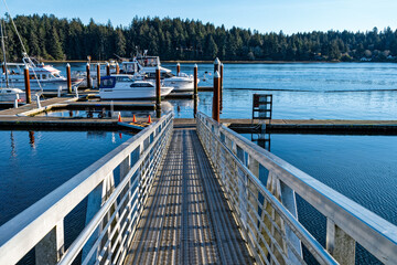 A metal walkway leads to the docks at the Port of Siuslaw Marina in Florence, Oregon, USA