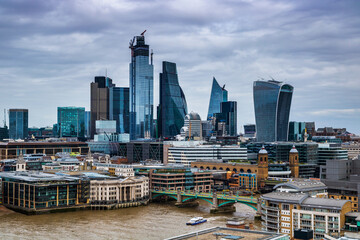 London city scape with cloudy sky and the Thames river.