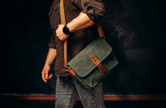 fashion, style and people concept - close up of hipster man with stylish shoulder bag