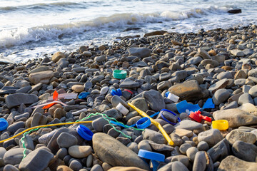 Plastic garbage on the beach. Environmental and ocean plastic pollution. Ecology and care for nature