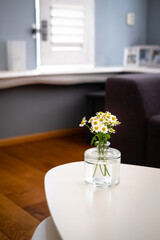 Fototapeta na wymiar Table with flowers in living room