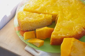 Pumpkin pie made of yellow sweet pumpkin baked in autumn and decorated with yellow leaves