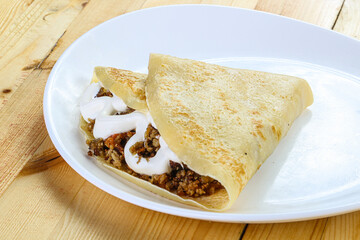 Pancake with minced meat and sauce