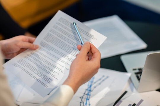 Businessman with pen and document in office