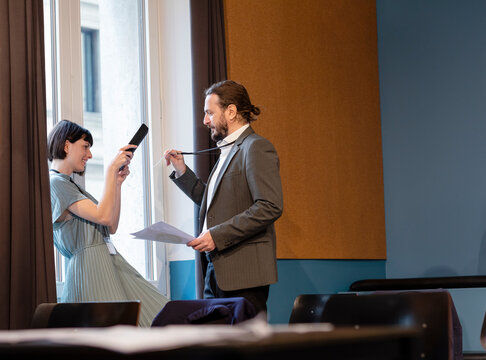 Businesswoman scanning identity card of colleague through tablet PC