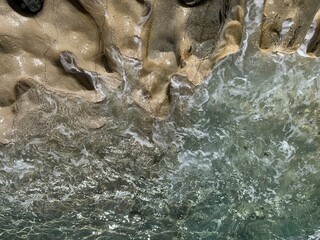 Fototapeta na wymiar Transparent azure sea water, rocky coastline