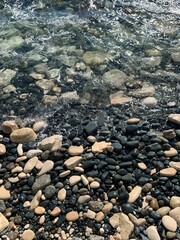 Big sea pebble and transparent water, natural background, sea coast