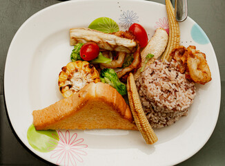 vegetables rosted with rice and butter bread in dish