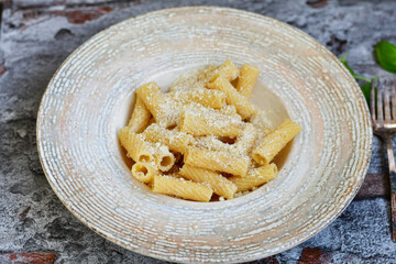  Italian home made  rigatoni   pasta  with  tuna  fish, parmesan cheese and black pepper .