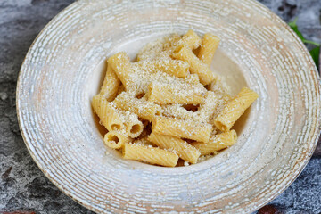  Italian home made  rigatoni   pasta  with  tuna  fish, parmesan cheese and black pepper .