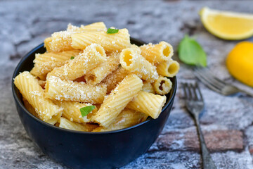  Italian home made  rigatoni   pasta  with  tuna  fish, parmesan cheese and black pepper .